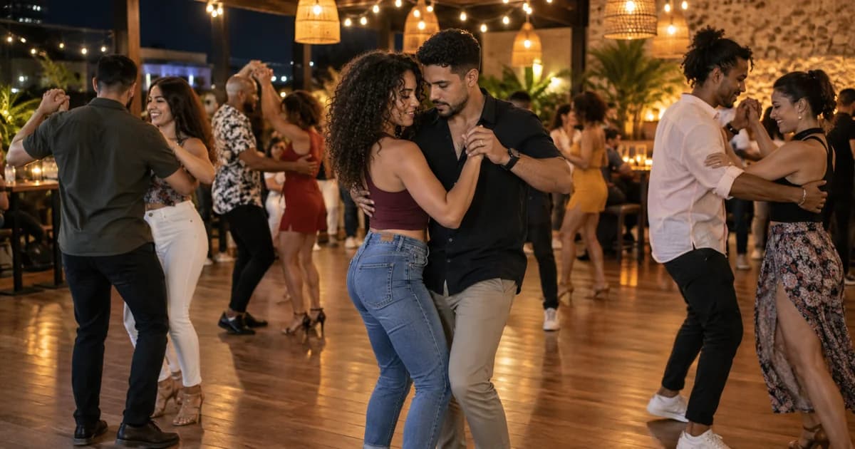 Several couples dancing under warm lights at an evening social